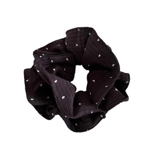 Dark brown scrunchie with white heart pattern and ribbed fabric for casual hairstyling