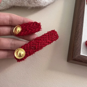 Vintage red tweed hair clip set with gold button accents on elegant fabric oval barrettes