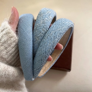 Three elegant light blue plaid sponge headbands with various woven textures for women