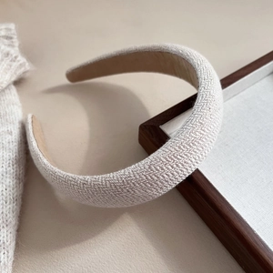 Close-up of oatmeal knit headband showing thick woven texture and matte lining detail