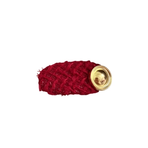 Vintage red tweed oval hair clip with gold metal button detail on a clean white background