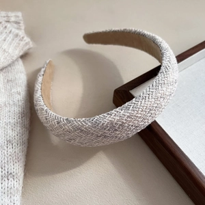 Close-up of beige tweed padded headband showing rich woven texture and thick sponge design