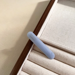 Macro view of light blue acetate hair clip with golden France Handmade lettering detail