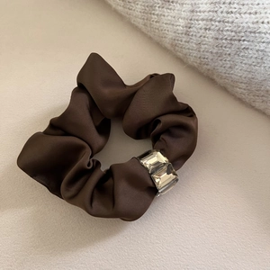 Deep brown satin scrunchie with rectangular crystal accents and elegant glossy finish