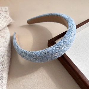 Close-up detail of light blue tweed padded headband with premium woven fabric texture