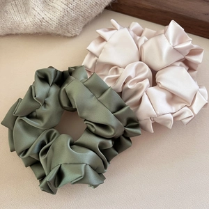 Set of large satin scrunchies in olive green and champagne with elegant ruffled edges