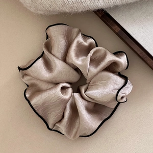 Champagne silk scrunchie with black trim detail for bun and ponytail styling