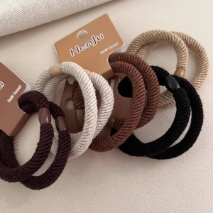 Thick elastic hair ties set in coffee tones with textured fabric and plastic buckles