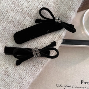 Set of vintage black velvet hair clips with elegant rhinestones in a bowknot design