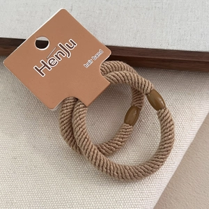 Two-piece set of thick elastic spiral hair bands in coffee brown on a display card