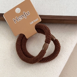 Two-pack of thick brown hair ties with twill texture and secure cylinder clasp