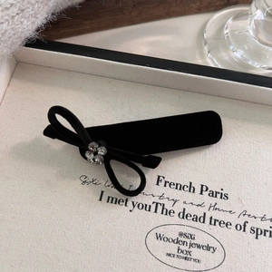 Elegant black velvet bow hair clip with sparkling rhinestones in a French vintage style