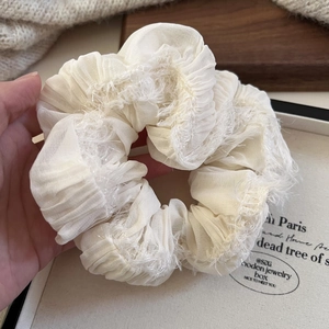 Elegant cream ruffled scrunchie with fringe detail and soft textured fabric for women