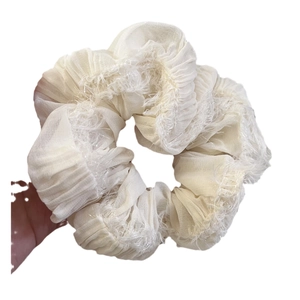 Creamy ruffled chiffon scrunchie with fringe edges for women's elegant ponytail styling