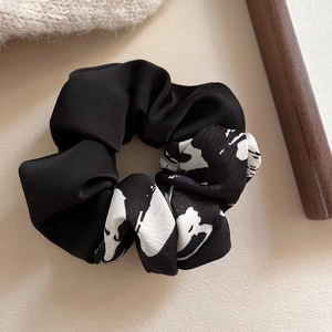 Elegant ink print satin scrunchie with a sleek black and white patchwork design