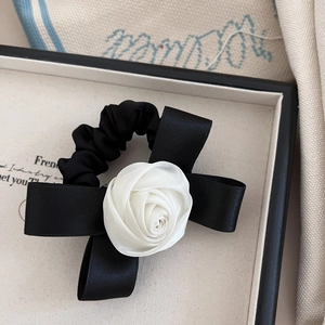 Elegant black satin bow hair tie with a white 3D Camellia flower and elastic scrunchie