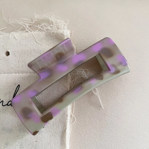 Elegant grey and purple leopard print hair claw clip on canvas background