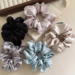 Set of 6 premium satin scrunchies in diverse pastel colors with elegant silky texture