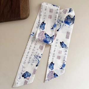 Detailed macro view of vintage silk hair ribbon with blue butterflies and ink calligraphy