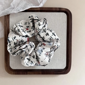 Retro Chinese style scrunchie with black ink calligraphy and red seal on white silk fabric