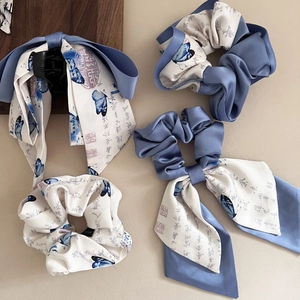 Detail of satin hair bows and scrunchies featuring traditional Chinese ink butterfly prints