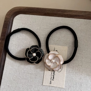Elegant camellia hair ties set with faux pearls and gold edges on high elastic bands