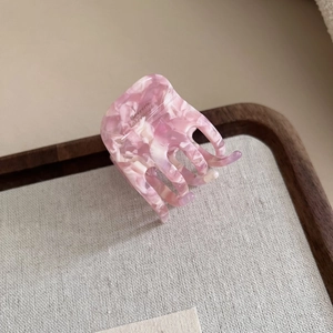 Detail of pink marble acetate hair claw showing Barrette La France gold engraving