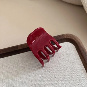 Detailed close-up of dark red acetate hair claw with golden Barrette La France lettering