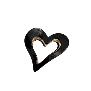 Elegant heart-shaped black acetate hair claw clip with gold metal teeth for high ponytail