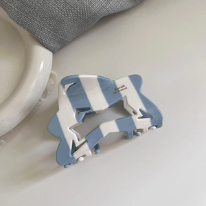 Blue and white striped acetate claw clip with star cutout design for elegant hairstyles