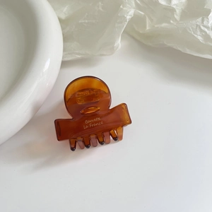 Elegant amber acetate hair claw clip with Barrette La France text for stylish ponytail