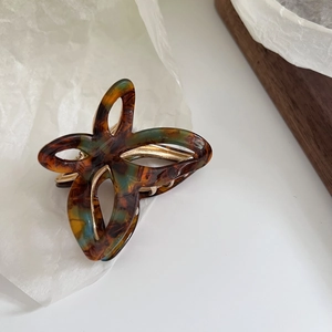 Elegant tortoiseshell acetate butterfly hair claw clip with golden metal spring frame
