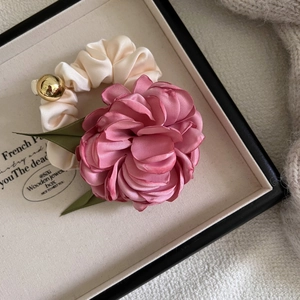 Elegant 3D pink camellia hair scrunchie with silk green leaves and a golden bead accessory