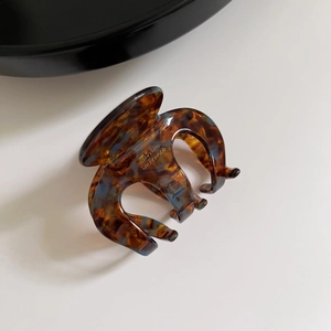 Detail view of tortoiseshell hair claw with Barrette la France gold lettering