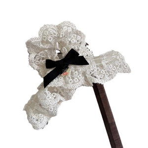 Elegant beige lace hair scrunchie with black satin bow and gold metal charm pendant