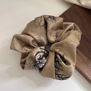 Elegant champagne satin scrunchie with traditional ink painting floral patterns
