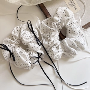 Close-up of polka dot pattern scrunchies with long silk ribbons for hair styling