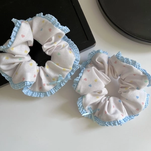 Set of two sweet ballet-style heart print hair scrunchies with blue plaid ruffle edges