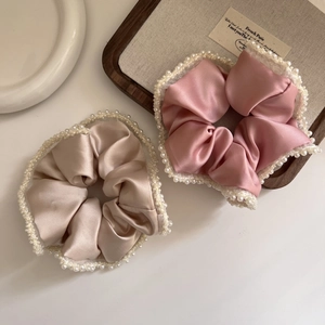 Elegant satin scrunchies with faux pearl lace trim in champagne and dusty rose colors