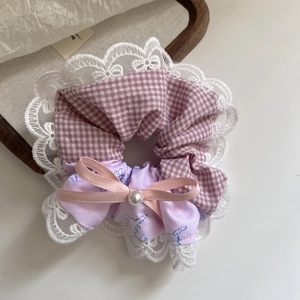 Pink plaid scrunchie with lace edge, ribbon bow, and pearl detail for ponytails