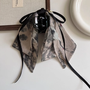 Detail of Chinese ink wash style silk ribbon bow claw clip with crane and pine patterns