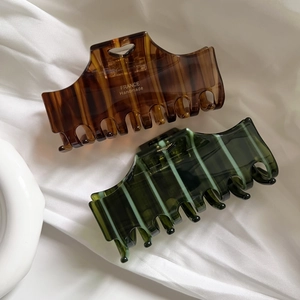 Elegant tortoiseshell and dark green acetate hair claw clips with striped pattern