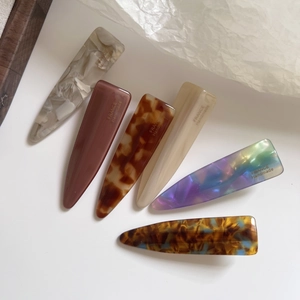 Set of six colorful amber-patterned acetate hair clips in various marble and tortoiseshell styles