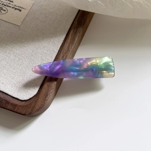 Elegant teardrop acetate hair clip featuring colorful mother-of-pearl patterns and golden logo