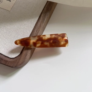 Detailed macro view of retro tortoiseshell acetate hair clip with France Handmade text