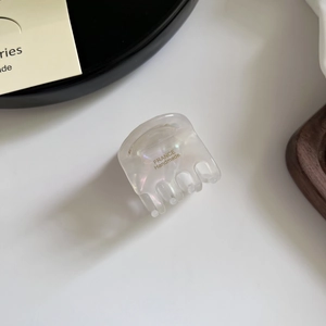 Detailed close-up of acetate hair clip with France Handmade logo and pearl finish