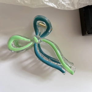 Green and blue bow-shaped acrylic hair claw clip with golden spring for women