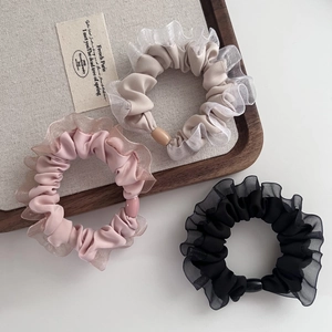Three minimalist mesh ruffle hair ties in beige, pink and black with matte accents