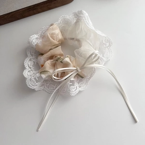 Floral print scrunchie with delicate white lace trim and a sweet ribbon bow decoration