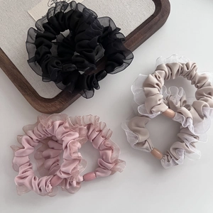 Three-piece mesh ruffle scrunchie set in black, pink and beige with cylinder buckles